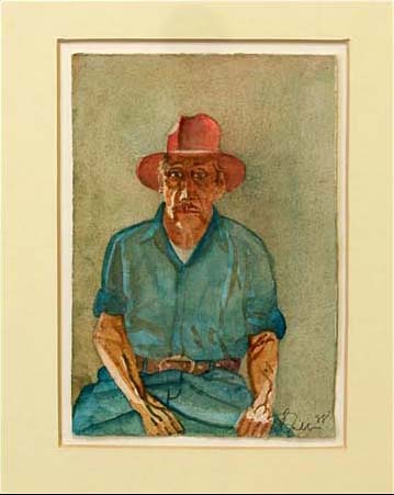 Portrait of an older man wearing a blue green shirt, blue jeans and a brown hat. 