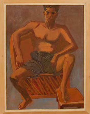 Young man wearing shorts sitting on a chair 