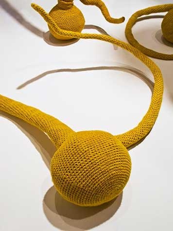 Yellow organicly shaped fiber art by Esther Traugot