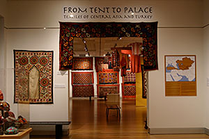 Gallery view of From Tent to Palace showing a display of rich colored textiles