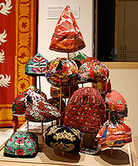 Display of bright and colorful embroidered skullcaps.  Kalpoq, Duppi, Tup, Tubeteika
