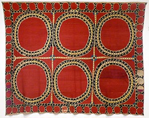 Suzani small rectangular red cloth with embroidered designs.  