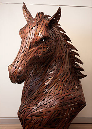 Side view of large brown horse head and torso created from cardboard and wood 