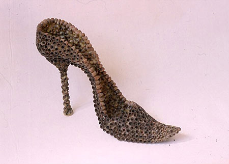 Sculpture of a high heel shoe made from seed pods and bee's wax 