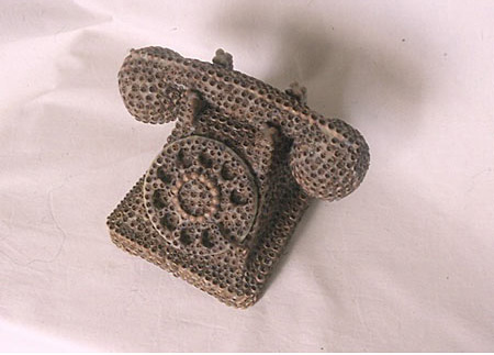 Sculpture of a telephone made of seed pods and bee's wax 
