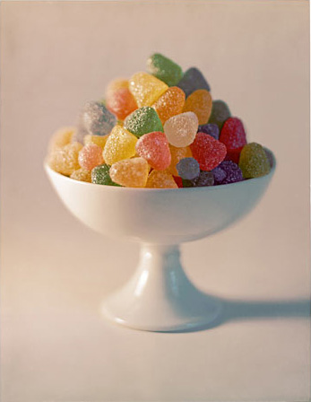 White bowl filled is colored gum drops 