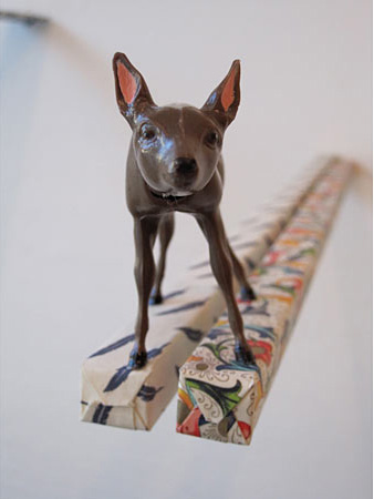 Deer standing on the edge of two thin paper forms 