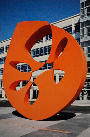 Photograph of large orange sculpture in a plaza  