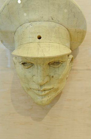 Man's head wearing a military hat 