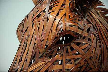 Detail of an eye.  Large brown horse head and torso created from cardboard and wood 