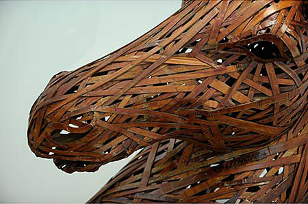 Detail of head. Large brown horse head and torso created from cardboard and wood 