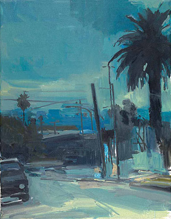City scene of a street with a palm tree in the forefront 