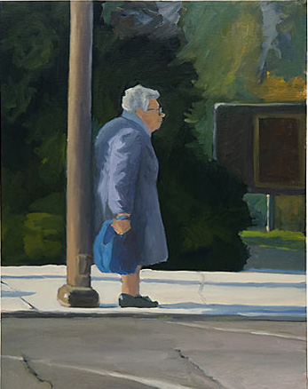 Elderly woman in a blue coat leaning on a light pole 