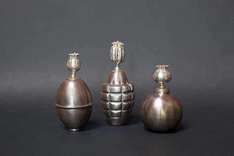Three opium jars that look like grenades by Evan Chambers