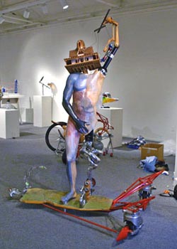 Abstracted sculpture of a nude man who has one arm in the air.  