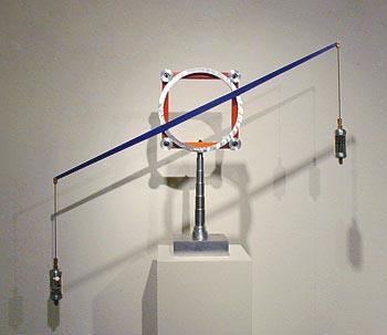 Abstracted sculpture that resembles a balance with weights