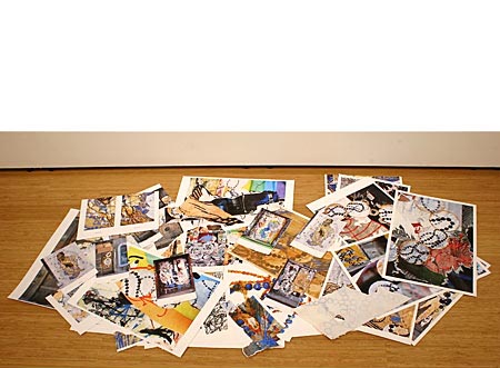 Pile of photographs placed on the floor.  Photos of Street Art  