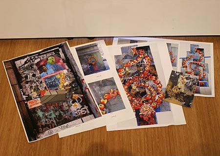 Street Art pile of photos placed on the floor.  The photos relate to the abstract above them 