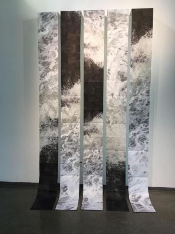 Five print panels that cascade downward onto the floor titled The Falls
