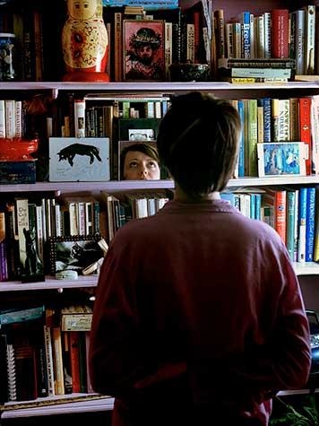 Photograph of a women looking at a bookcase by Jessica Sue Layton