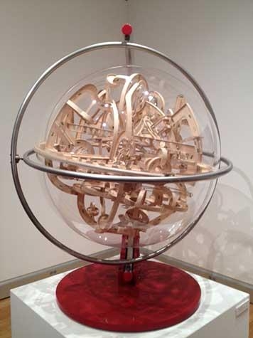 Sculpture of sphere with intwined wood inside by Michael McGinnis